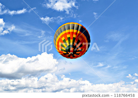 Colorful hot air balloon flying over blue sky with white clouds Colorful hot air balloon flying over blue sky with white clouds 118766458