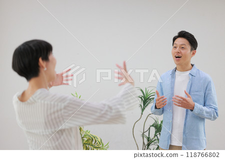 A man doing vocal training and a female trainer giving instructions with big gestures_1 A man doing vocal training and a female trainer giving instructions with big gestures_1 118766802