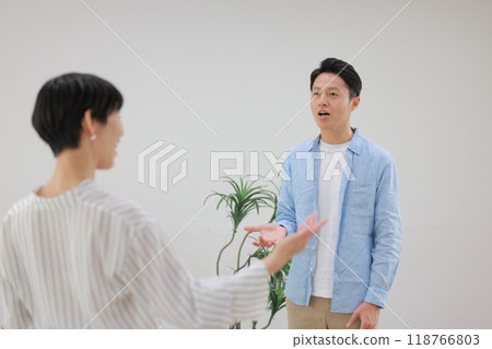 A man doing vocal training and a female trainer giving instructions with big gestures_2 A man doing vocal training and a female trainer giving instructions with big gestures_2 118766803
