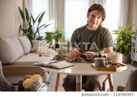 Hipster creative man crochet handmade use knitting supplies hook and wool yarn at home Hipster creative man crochet handmade use knitting supplies hook and wool yarn at home 118766901