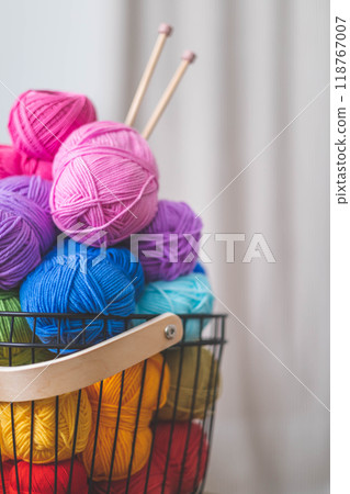 Lots of bright, colorful yarns for knitting and crochet in a stylish scandi style basket.  118767007