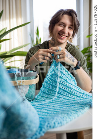 Man hands crochets handmade crocheting supplies assorted wool yarn hook knitting top view closeup 118767026