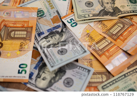 Close-up of scattered Euro and US dollar banknotes. Symbolizes international currency exchange and global finance.  118767129