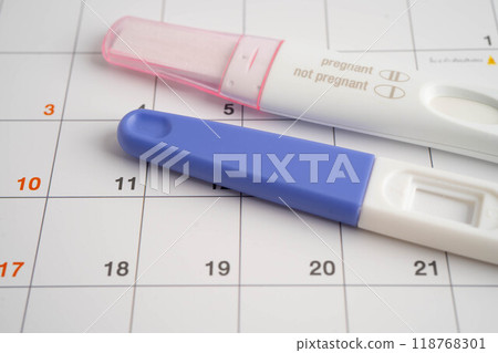 Pregnancy test and birth control pills on calendar, contraception health and medicine. Pregnancy test and birth control pills on calendar, contraception health and medicine. 118768301