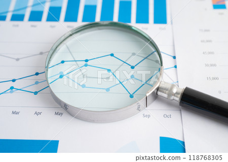 Magnifying glass on graph. Finance business and trading. Magnifying glass on graph. Finance business and trading. 118768305