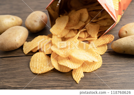 Potato chips , delicious BBQ seasoning spicy for crips, thin slice deep fried snack fast food. 118768626