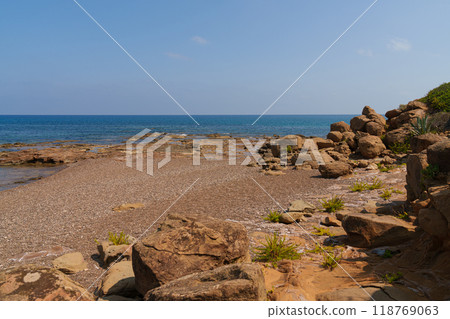 Rocky Mediterranean Shoreline with Clear Blue Sea 118769063
