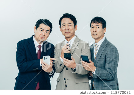Middle-aged businessman looking at smartphone Middle-aged businessman looking at smartphone 118770081