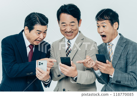 Middle-aged businessman looking at smartphone Middle-aged businessman looking at smartphone 118770085