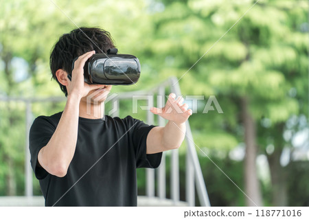 A man wearing VR goggles and experiencing virtual reality Metaverse 118771016