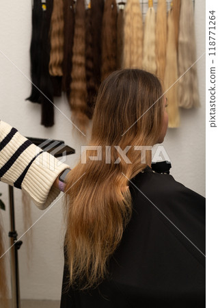 The hairdresser holds the strands of the client's hair in his hands. Barbershop The hairdresser holds the strands of the client's hair in his hands. Barbershop 118771264