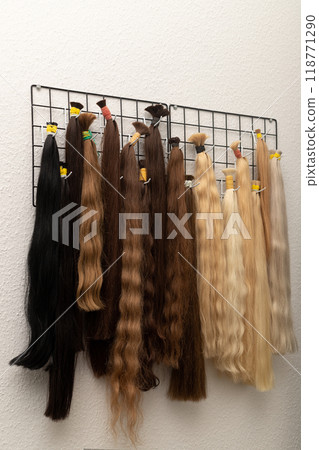 Hairdresser's workplace. Hair strands for extensions. Sale of women's hair Hairdresser's workplace. Hair strands for extensions. Sale of women's hair 118771290