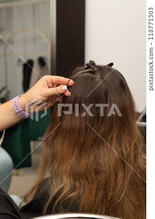 Hairdresser works with the client's hair. Workflow in a beauty salon. Barbershop Hairdresser works with the client's hair. Workflow in a beauty salon. Barbershop 118771303