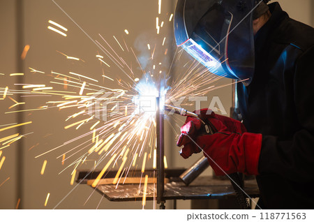 A man learns the craft of welding on a sample. A man learns the craft of welding on a sample. 118771563