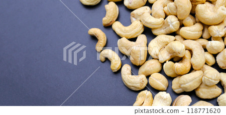 Cashew nuts on dark background. Cashew nuts on dark background. 118771620