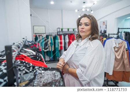 Caucasian fat woman chooses clothes. Plus size store. Caucasian fat woman chooses clothes. Plus size store. 118771733