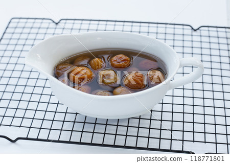 Pickled plums on white background. Pickled plums on white background. 118771801