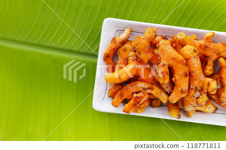 Turmeric roots on banana leaf 118771811