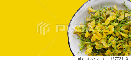 Sesbania flower on yellow background. Sesbania flower on yellow background. 118772140