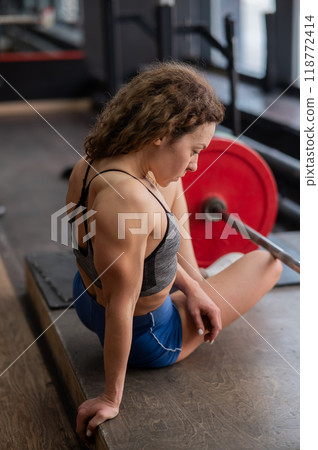 Middle aged woman posing in the gym.  118772414