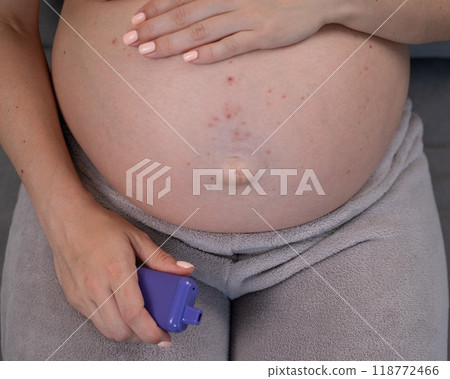 A pregnant woman smokes a vape while sitting on... - Stock Photo  [118772466] - PIXTA