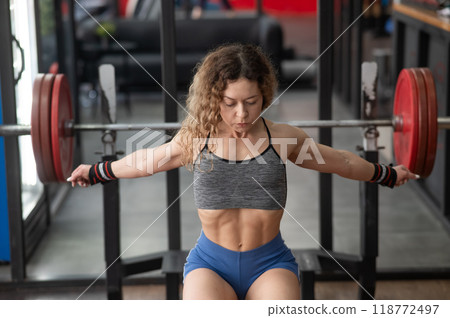 Middle aged woman warming up before bench press at the gym.  118772497