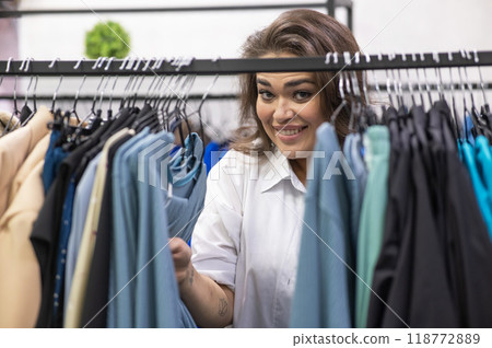 Smiling fat woman in plus size store looking at camera. Smiling fat woman in plus size store looking at camera. 118772889