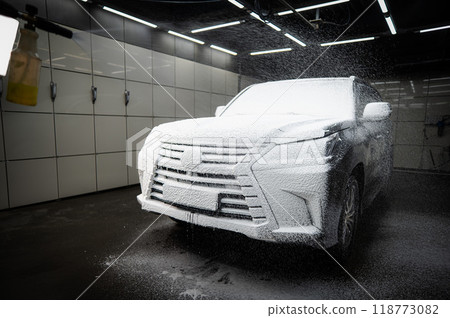 Black car covered in cleaning foam. Black car covered in cleaning foam. 118773082