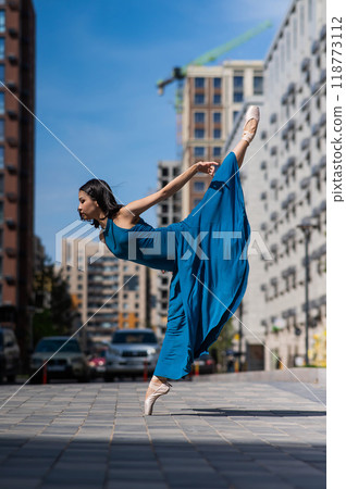 Beautiful Asian ballerina dancing outdoors. Urban landscape. Beautiful Asian ballerina dancing outdoors. Urban landscape. 118773112