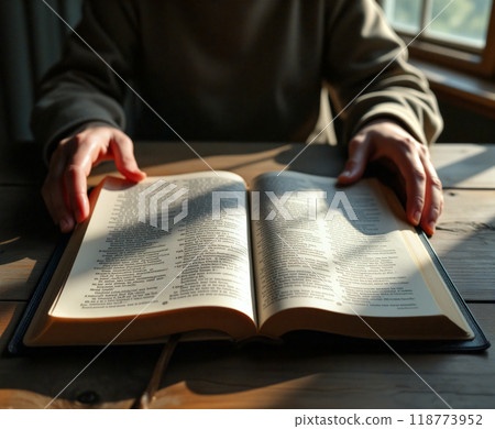 Woman reading the holy bible at home under sunlight Woman reading the holy bible at home under sunlight 118773952