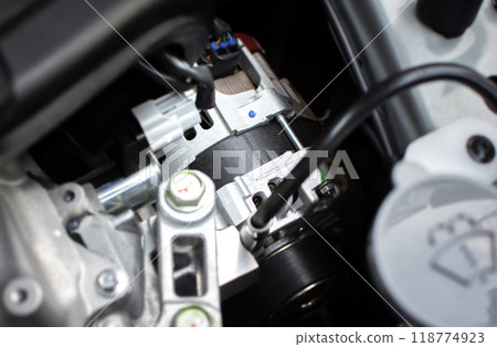 Close up of car generator or alternator in engine compartment 118774923