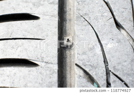 Tire tread wear indicator, Close up of tire with tire tread wear indicator showing on tread grooves 118774927