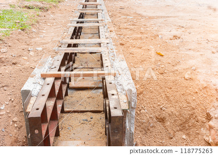 concrete drainage gutter on construction site on road 118775263