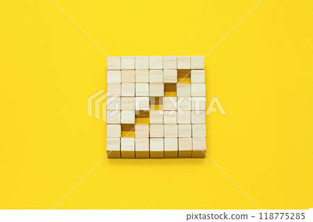 A three-dimensional block icon with a staircase-shaped mark on a yellow background A three-dimensional block icon with a staircase-shaped mark on a yellow background 118775285