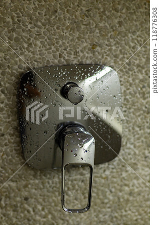 water drops on a chrome shower faucet 118776308