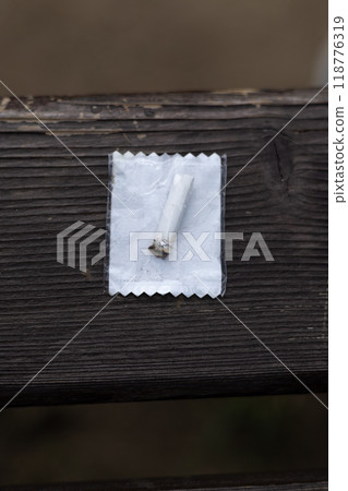 lighters in a cellophane bag on a wooden background 118776319