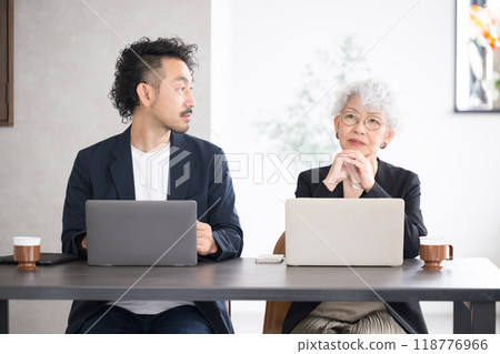 Image of an elderly female manager, chairman, or president discussing business, sales, or a meeting Smiling, happy, talking Image of an elderly female manager, chairman, or president discussing business, sales, or a meeting Smiling, happy, talking 118776966