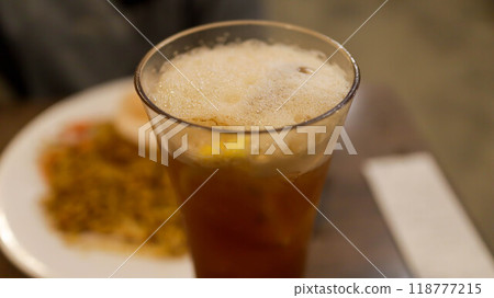A glass of ice lemon tea with a slice of lemon inside on the table. A glass of ice lemon tea with a slice of lemon inside on the table. 118777215