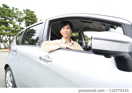 Young asian man driving with a smile 118778191