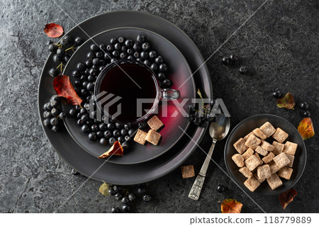 Black chokeberry juice, fresh berries, and pieces of brown sugar. Black chokeberry juice, fresh berries, and pieces of brown sugar. 118779889