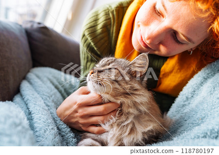 portrait red-haired attractive young woman with fluffy big cat 118780197