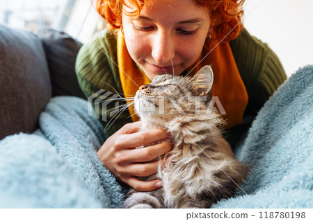 portrait red-haired attractive young woman with fluffy big cat 118780198