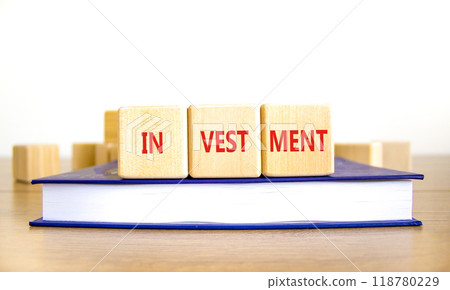 Investment symbol. Concept word Investment on beautiful wooden blocks. Beautiful wooden table white background. Beautiful book. Business investment concept. Copy space. Investment symbol. Concept word Investment on beautiful wooden blocks. Beautiful wooden table white background. Beautiful book. Business investment concept. Copy space. 118780229