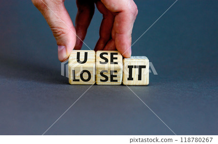 You use or lose it symbol. Concept word Use It or lose it on wooden cubes. Beautiful grey table grey background. Businessman hand. Business and you use or lose it concept. Copy space. You use or lose it symbol. Concept word Use It or lose it on wooden cubes. Beautiful grey table grey background. Businessman hand. Business and you use or lose it concept. Copy space. 118780267