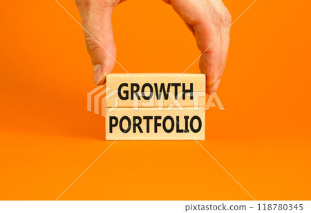 Growth portfolio symbol. Concept words Growth portfolio on beautiful wooden block. Beautiful orange paper background. Businessman hand. Business Growth portfolio concept. Copy space. Growth portfolio symbol. Concept words Growth portfolio on beautiful wooden block. Beautiful orange paper background. Businessman hand. Business Growth portfolio concept. Copy space. 118780345