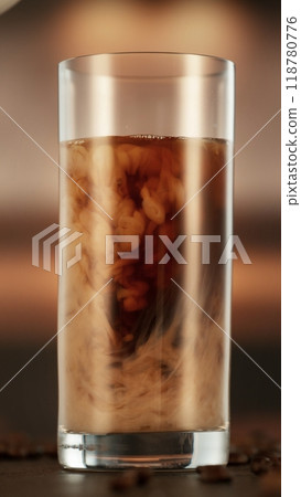 Mixing Milk in Coffee Drink in Detail. 118780776