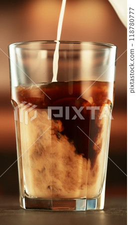 Pouring Milk into Coffee Drink in Detail. Pouring Milk into Coffee Drink in Detail. 118780777