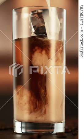 Pouring Milk into Ice Coffee Drink in Detail. 118780795