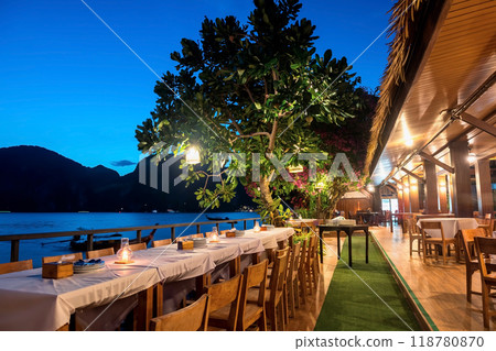 Dinner group table of restaurant patio by Phi Phi Don seashore, Krabi Dinner group table of restaurant patio by Phi Phi Don seashore, Krabi 118780870