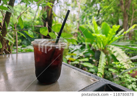 iced americano coffee on table of outdoor cafe garden 118780878